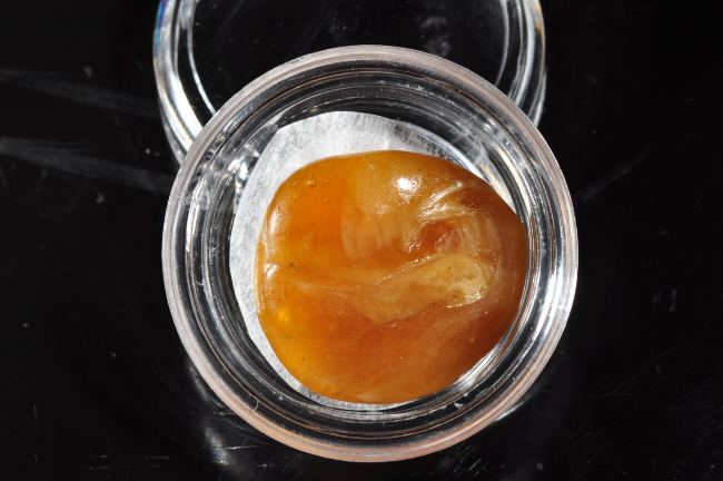 orange cannabis wax in a clear container