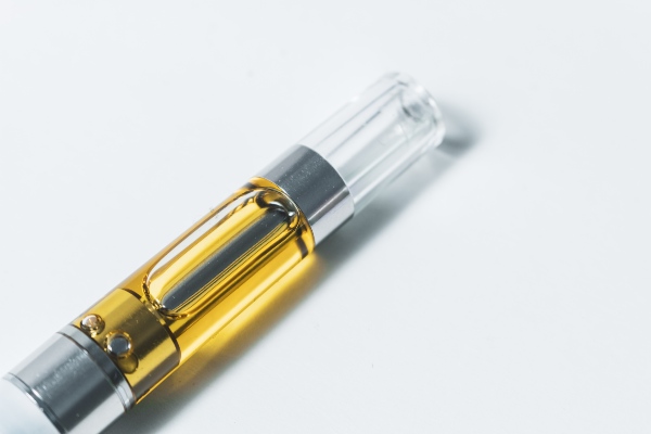 A golden-yellow liquid filled silver metal cartridge with clear mouth tip
