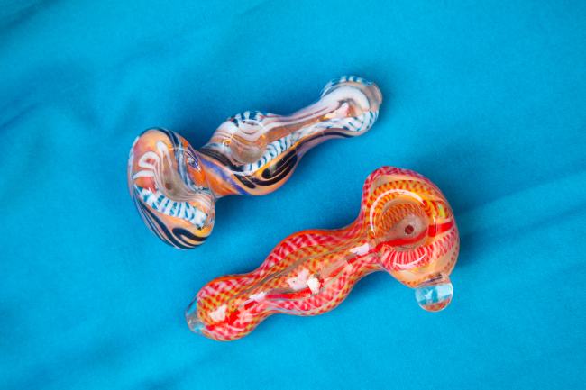 two colorful cannabis bowls next to each other