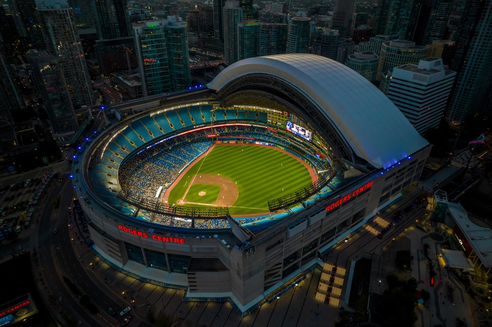 Birdsâ eye view of the Rogers Centre dome open during a Blue Jays baseball game in the early evening.